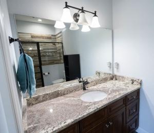 a bathroom with a sink and a mirror at Pondfront Ranch • Theater Room • Sleeps 8 in Eagle Lake +27 photos