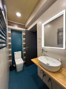 a bathroom with a sink and a toilet at Fairytale Apartment in Aghk'ilisa