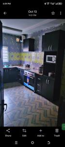 a kitchen with a stove top oven in a room at KOOZE Integrated Services Ltd 
