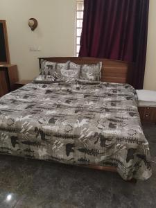 a bed with a comforter and pillows on it at KOOZE Integrated Services Ltd 