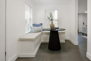 a table with a vase on it in a room at Beachside Bliss - Beach House Unit 2 in Jacksonville Beach