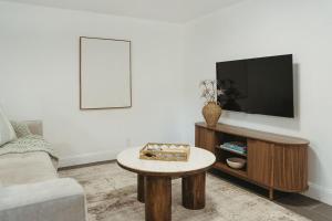 a living room with a tv and a coffee table at Beachside Bliss - Beach House Unit 2 in Jacksonville Beach