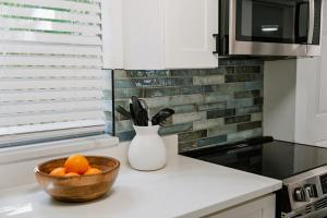 a kitchen with a bowl of oranges on a counter at Beachside Bliss - Beach House Unit 2 in Jacksonville Beach +1 photo