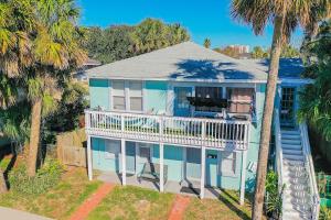 an aerial view of a house with a balcony and palm trees at Beachside Bliss - Beach House Unit 2 in Jacksonville Beach