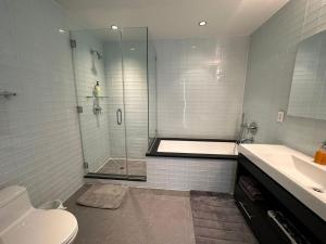 un bagno con doccia, WC e lavandino di Time Square Condos a New York