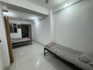 a bedroom with two beds in a room at Mahayaatri Niwas in Kolhapur +4 photos