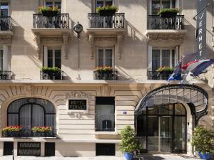 a facade of a building with flower boxes on the windows at Hôtel Vernet Champs Elysées Paris in Paris