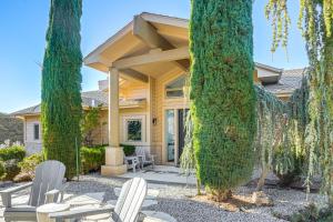 a house with two trees and chairs in front of it at Prescott Gem Hot Tub and Mtn Views, 7 Mi to Dtwn in Prescott