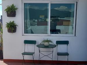two chairs and a table in front of a window at Terraza Amecameca in Amecameca de Juárez
