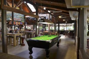 a room with a pool table in a restaurant at PK's Jungle Village in Cape Tribulation