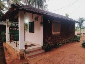 a small house with a staircase leading to it at Gokarna Royal Cottage in Gokarna