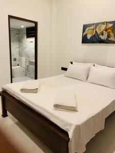 En eller flere senge i et værelse på Dasis villa