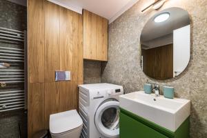 a bathroom with a washing machine and a sink at Best Residence - High-End Suites - by Solinis Homes in Bucharest +291 photos
