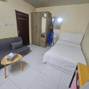 une chambre avec un lit, un canapé et une table dans l'établissement Kady and Kojic Hideout, à Al-Aïn