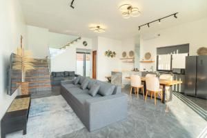 a living room with a couch and a table at Shukty Villa Pandawa in Ungasan
