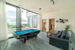 a living room with a pool table and a couch at Shukty Villa Pandawa in Ungasan