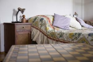 a bedroom with a bed with a lamp on a night stand at Zámek Nemilkov in Velhartice +7 photos