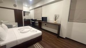 ein Hotelzimmer mit Bett und Fernseher in der Unterkunft Eolie Loft in Colombo