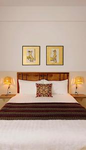 a bedroom with a large white bed with two lamps at 131 inn in Tainan