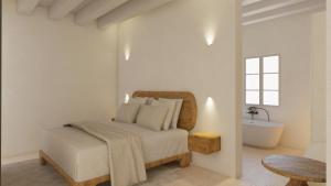 En eller flere senge i et værelse på LLONGA'S Born Suites & Spa