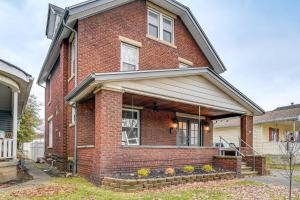 ein rotes Backsteinhaus mit einem Fenster und einer Veranda in der Unterkunft Walk to Marshall University Home with Private Yard! in Huntington
