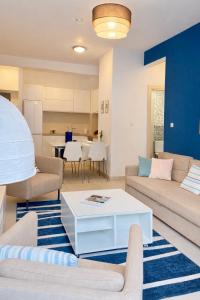a living room with a couch and a table at One-Bedroom Apartment with Terrace, Sea View, Pool and Spa Lavender Bay Morinj in Donji Morinj