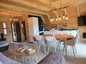 a kitchen and dining room with a table and chairs at Tomina Koliba Lika in Sveti Rok