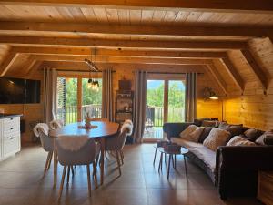 a living room with a couch and a table at Tomina Koliba Lika in Sveti Rok