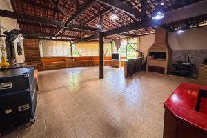 a large room with a large room with a fireplace at Recanto Bamboo in Lavrinhas