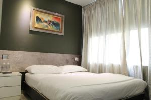Postel nebo postele na pokoji v ubytování M Design Hotel @ Seri Kembangan