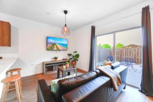 a living room with a couch and a large window at Spacious Townhouse W Free Parking in Miami