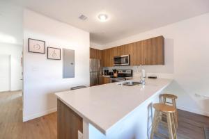 a kitchen with a white counter top and wooden cabinets at Spacious Townhouse W Free Parking in Miami