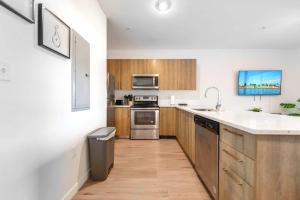 a kitchen with stainless steel appliances and wooden cabinets at Spacious Townhouse W Free Parking in Miami +6 photos