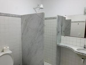 a bathroom with a shower and a toilet and a mirror at Hotel Pousada Dos Ventos in Parnaíba +45 photos