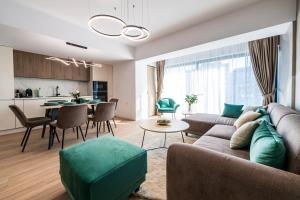 a living room with a couch and a table at Best Residence - High-End Suites - by Solinis Homes in Bucharest