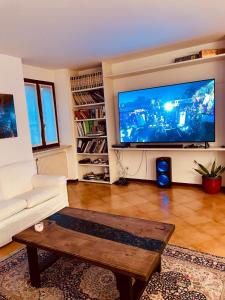 Attico in centro في أوديني: غرفة معيشة مع تلفزيون بشاشة مسطحة كبيرة