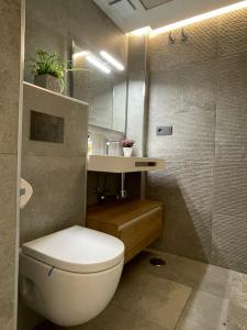 a bathroom with a white toilet and a sink at Alicante City Suite 2 in Alicante +42 photos