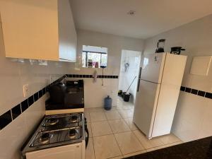 eine Küche mit Herd und Kühlschrank in der Unterkunft Vila Bella Residence in Gravatá