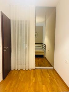 a bedroom with a mirror and a bed in it at Sunshine in Budva