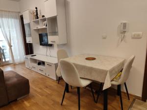 a dining room with a table and chairs in a room at Sunshine in Budva