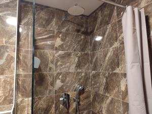 a bathroom with a shower with a glass door at Sunshine in Budva +11 photos