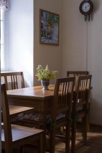 a dining room table and chairs with a vase on it at Zámek Nemilkov in Velhartice