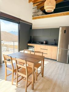 a kitchen with a wooden dining table and chairs at Apartamentos Algodonales in Algodonales