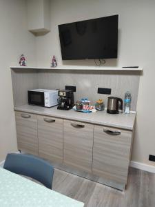 a kitchen with a microwave and a tv on a counter at Ca' da Lisa in San Colombano Certenoli