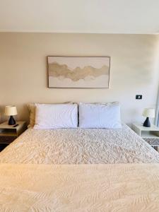 En eller flere senge i et værelse på Departamento en Península