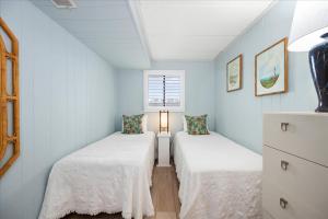 two beds in a room with blue walls at 2 Bedroom Ocean Block Condo, Steps to the Beach! in Ocean City