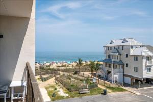 a view of the beach from the balcony of a beach house at 2 Bedroom Ocean Block Condo, Steps to the Beach! in Ocean City