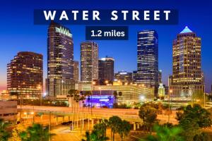a city skyline at night with the words water street miles at Chic Channelside Studio | Perfect Gate Away! in Tampa