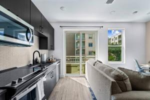 a kitchen with a sink and a couch in a room at Chic Channelside Studio | Perfect Gate Away! in Tampa