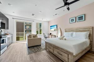 a bedroom with a large bed and a kitchen at Chic Channelside Studio | Perfect Gate Away! in Tampa +14 photos